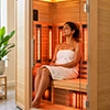 Woman relaxing in a modern far infrared sauna experiencing therapeutic heat and wellness benefits