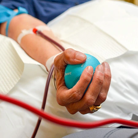 A patient undergoing EBOO therapy for blood oxygenation and purification in a clinical setting.