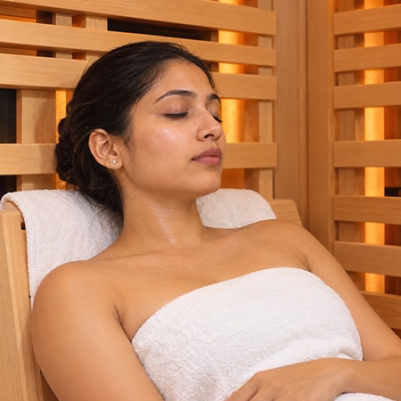 Patient receiving infrared sauna therapy for fibromyalgia relief.