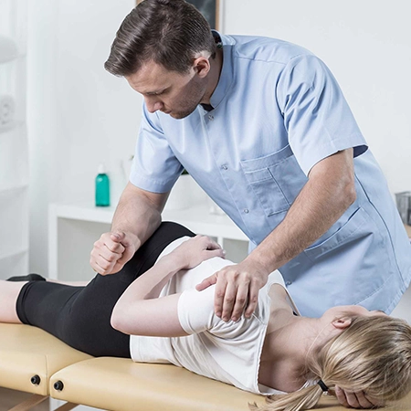 A trained therapist performing spinal manipulation treatment on a patient at Medical Wellness Centre.